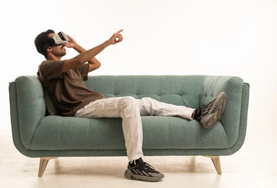 Saudi Man Using VR Headset on Sofa