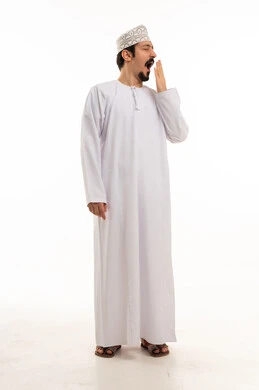 Omani Man Yawning in Traditional White Dishdasha
