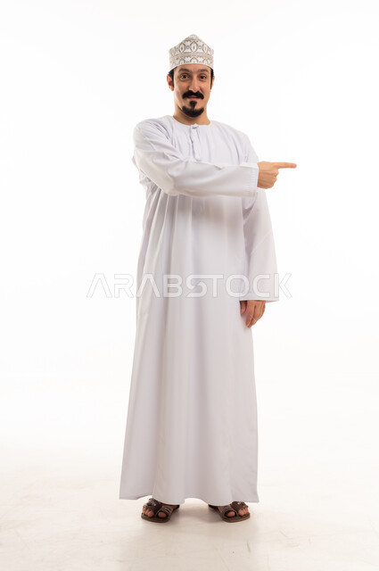Omani Man in Traditional Dress Pointing to Side