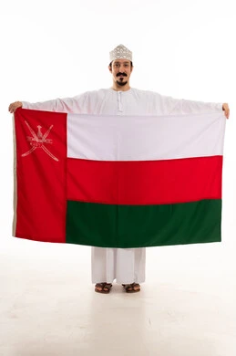 Omani Man Holding National Flag on White Background