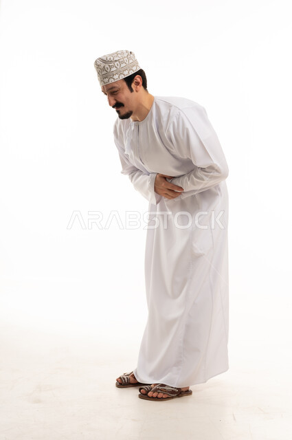 Omani Man in Traditional Dress with Stomach Pain