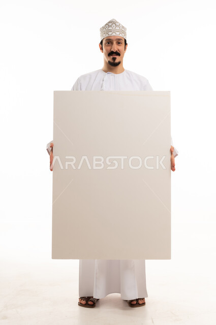 Omani Man in Traditional Dress Holding Blank Board