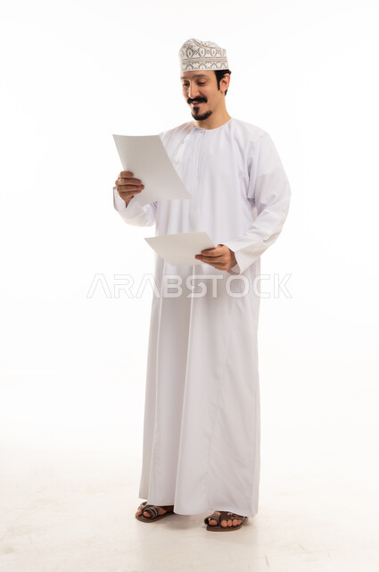 Omani Man Reading Documents on White Background
