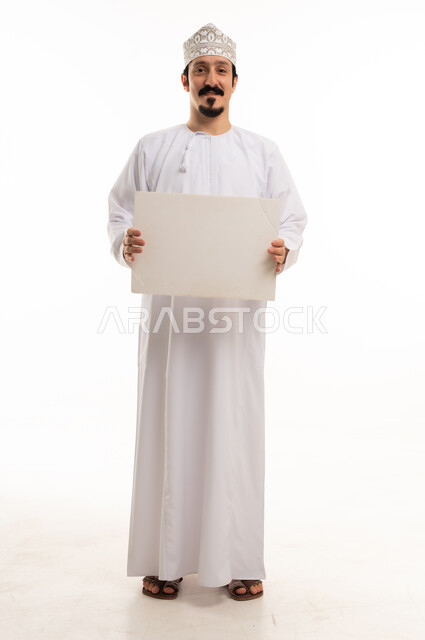 Omani Man in Traditional Dress Holding Blank Sign