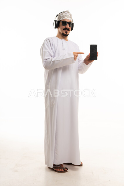 Omani Man in Traditional Dress Pointing at Smartphone