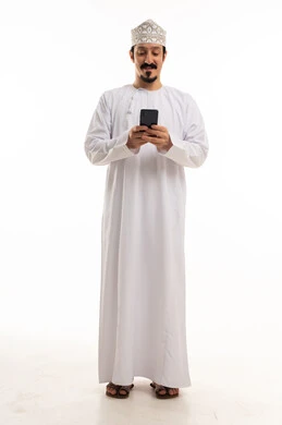 Omani Man in Traditional Dress Using Smartphone