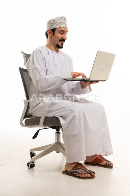 Omani Man Using Laptop on White Background