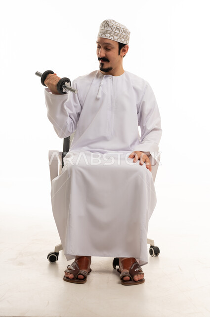Omani Man Exercising with Dumbbell in Office Chair