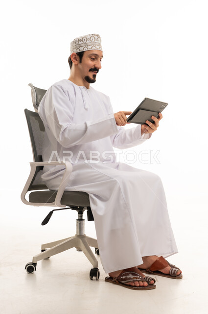 Omani Man Using Digital Tablet on Office Chair