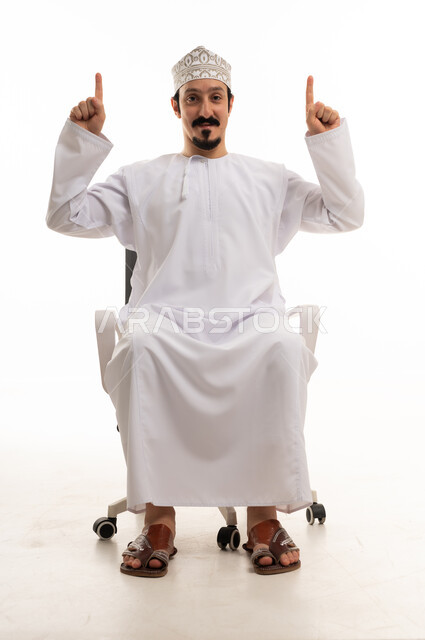 Omani Man in Dishdasha Pointing Up on White Background