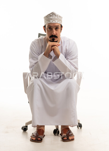 Omani Man in Traditional Dishdasha on Office Chair