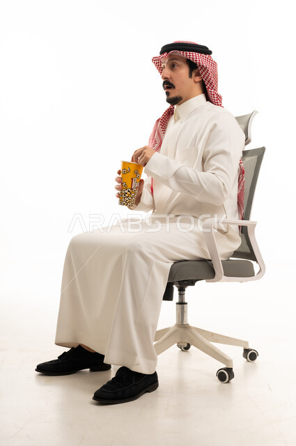 Surprised Saudi Man Holding Popcorn in Studio