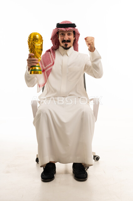Saudi Man Holding Golden World Cup Trophy in Studio