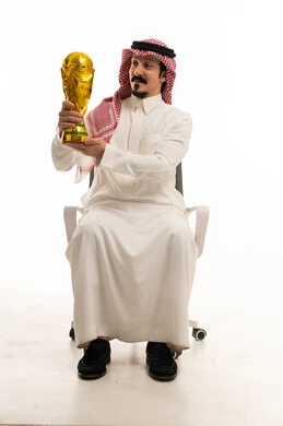 رجل سعودي يحمل كأس كرة قدم ذهبي