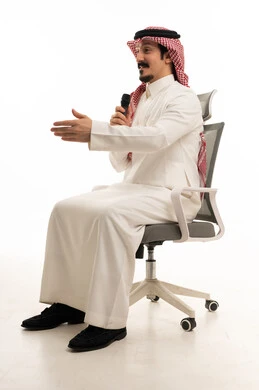 Saudi Man Speaking with Microphone on Office Chair