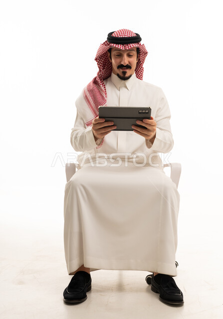 Saudi Man Using Digital Tablet on White Background
