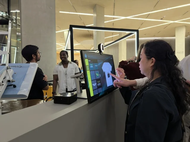 Woman Using Interactive Touchscreen at Ithra Dhahran