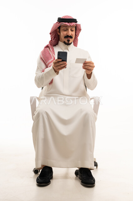 Saudi Man Using Smartphone and Credit Card on White