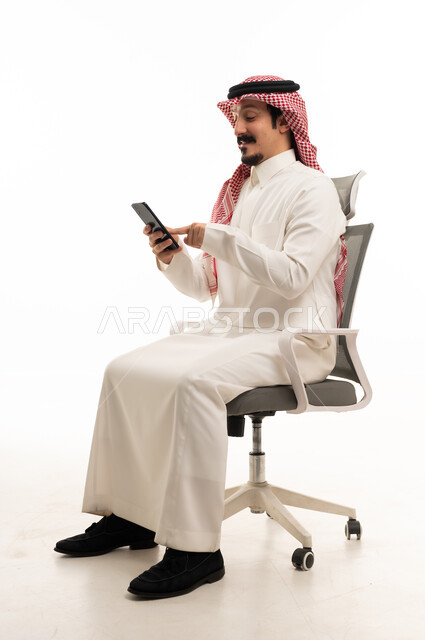 Saudi Man Using Smartphone on Office Chair White Background