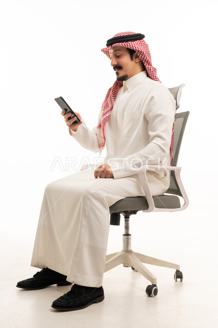 Saudi Man Using Smartphone on Office Chair