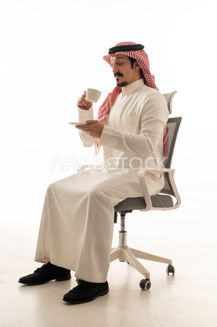 Saudi Man in Traditional Thobe Drinking Coffee
