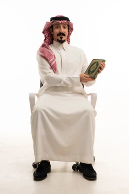 Saudi Man Holding Holy Quran on White Background