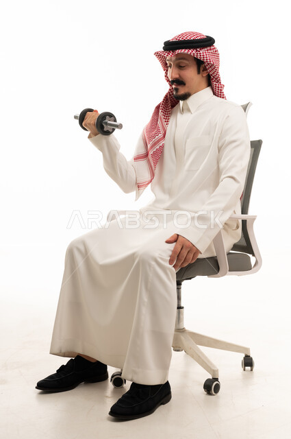 Saudi Man in Thobe Lifting Dumbbell in Office