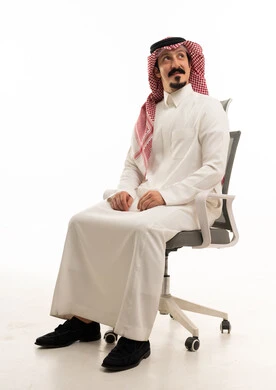 Saudi Businessman Sitting in Office Chair Looking Up