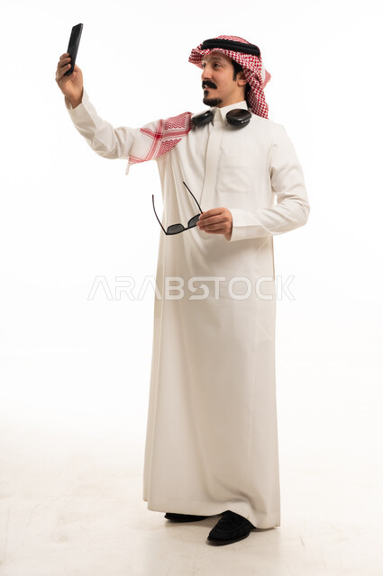 Saudi Man in Traditional Thobe Taking Selfie