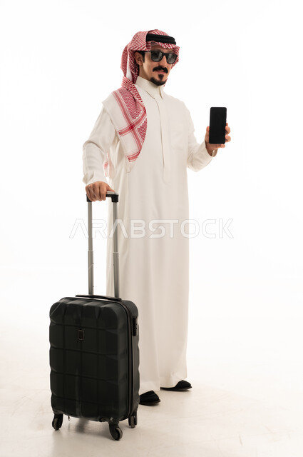 Saudi Man with Suitcase and Smartphone on White Background