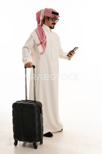 Saudi Man with Suitcase and Smartphone on White