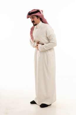 Saudi Man in Thobe with Stomach Pain on White Background