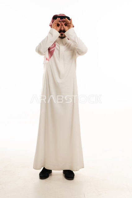 Saudi Man in Thobe Making Binoculars Hand Gesture