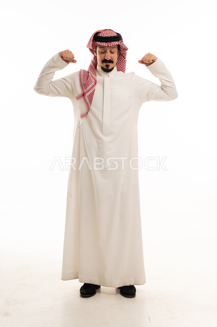 Saudi Man in Traditional Thobe Flexing Arm Muscles