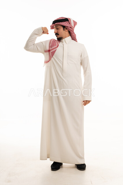 Saudi Man Flexing Muscles in Traditional Thobe