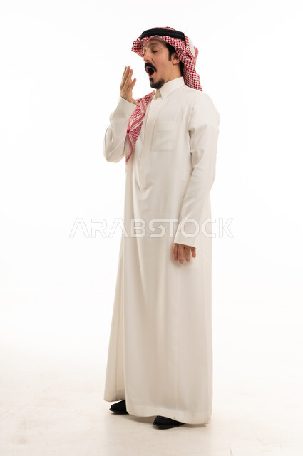 Saudi Man Yawning in Traditional Thobe White Background