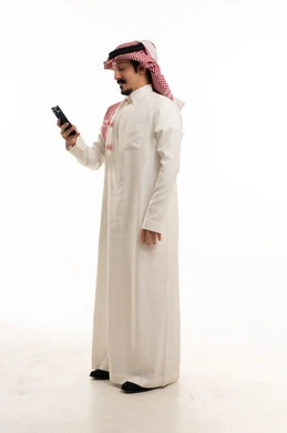 Saudi Man in Traditional Thobe Using Smartphone