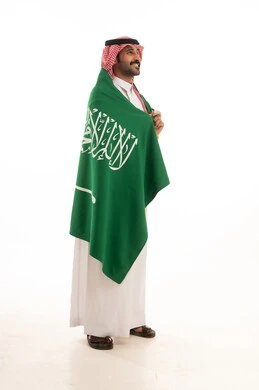 Saudi Man with Flag in Traditional Thobe and Shemagh