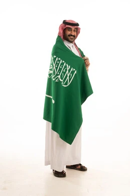 Saudi Man in Thobe Holding Saudi Arabia Flag