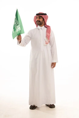 Saudi Man in Traditional Thobe Holding National Flag