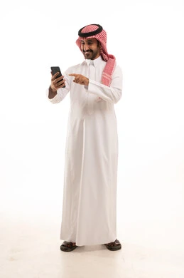 Saudi Man in Traditional Thobe Using Smartphone
