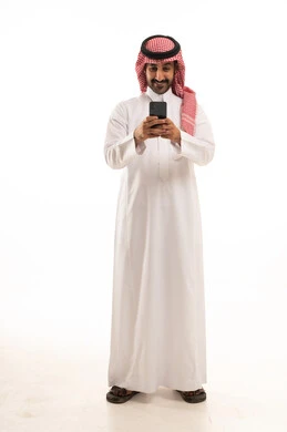 Saudi Man in Traditional Thobe Using Smartphone