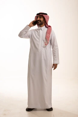 Saudi Man in Thobe Talking on Mobile Phone