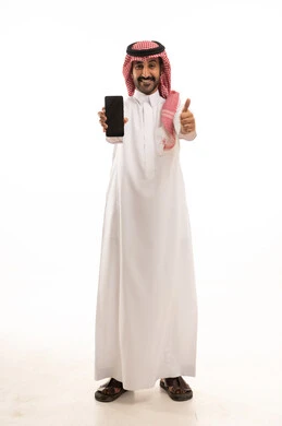 Saudi Man in Thobe Holding Smartphone with Thumbs Up
