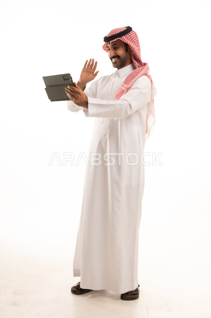 Saudi Man in Traditional Thobe Using Tablet Video Call