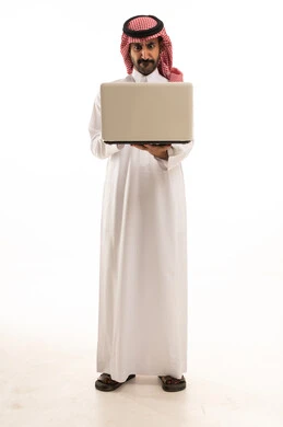 Saudi Man in Thobe and Shemagh with Laptop