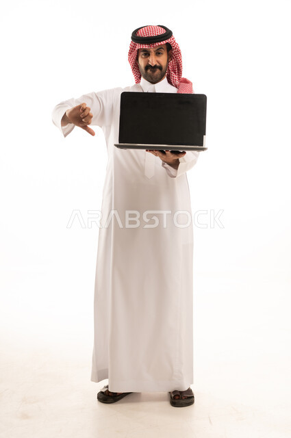 رجل سعودي يحمل لابتوب مع إشارة عدم إعجاب