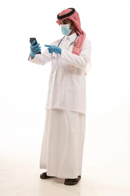 Saudi Male Doctor in Traditional Thobe Using Smartphone