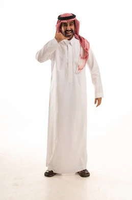 Saudi Man in Traditional Thobe Making Call Me Gesture