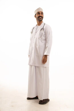 A portrait of an Arab Gulf Omani doctor wearing a dishdasha, turban, medical coat, and mask, holding a stethoscope, working in the healthcare sector, full-body, white background.